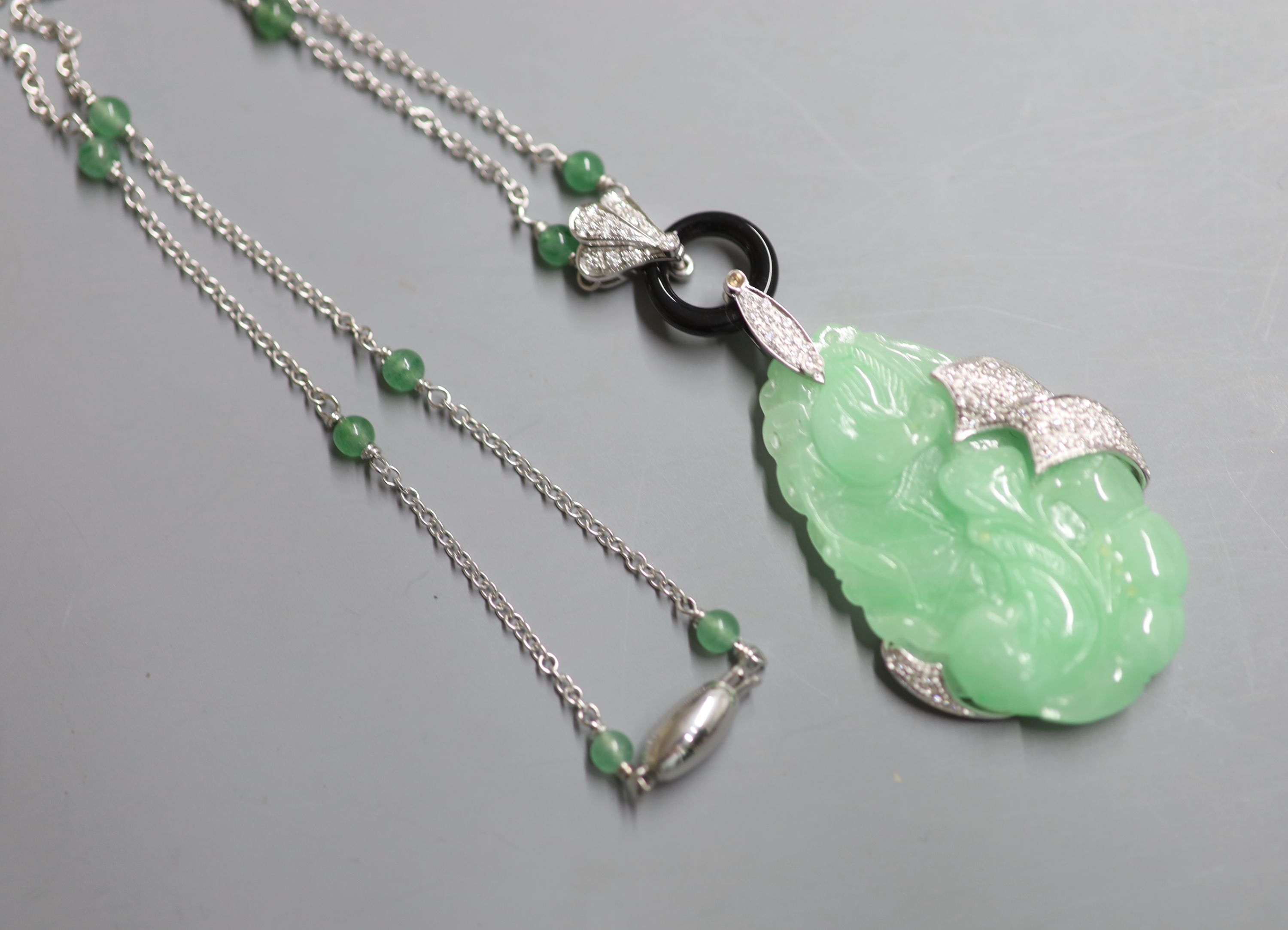 A modern Italian 750 white metal, jadeite, black onyx and diamond set pendant necklace,